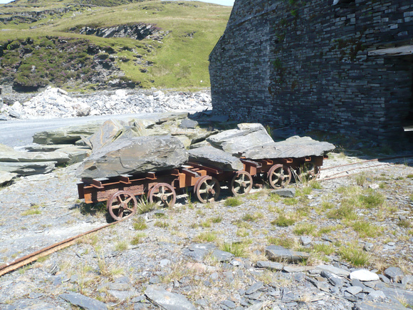 A trio of rudimentary slate wagons loaded and just outside the mill